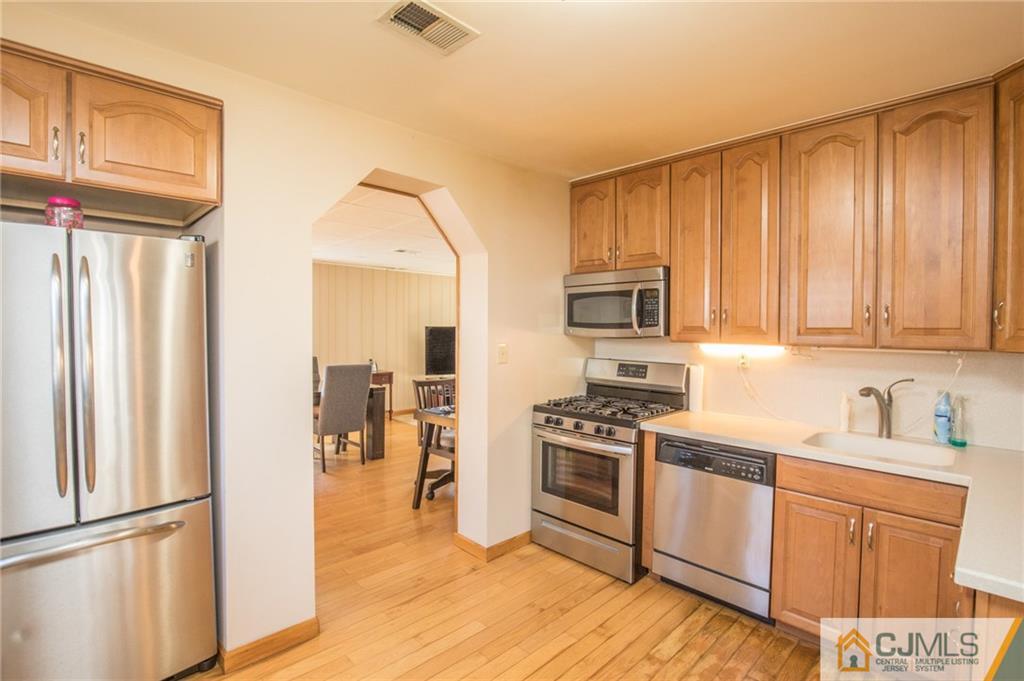 48 Caldwell Road Edison, NJ 08817 - Photo 16 of 24 a kitchen with stainless steel appliances granite countertop a refrigerator stove and sink