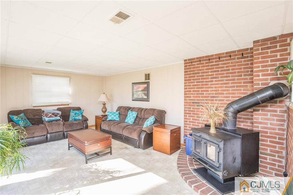48 Caldwell Road Edison, NJ 08817 - Photo 18 of 24 a living room with furniture and a fireplace