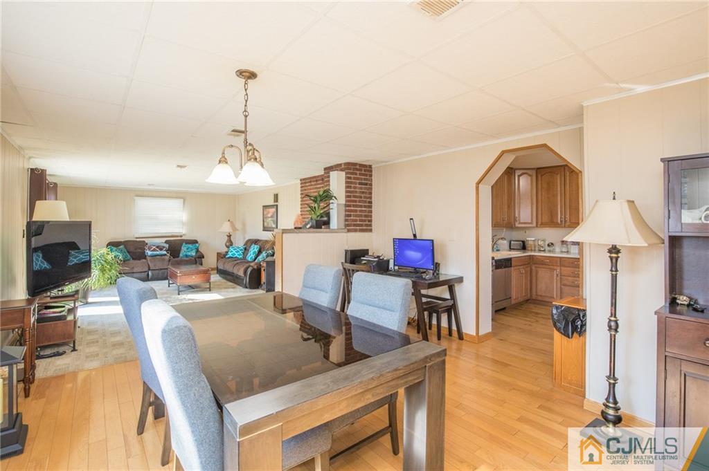 48 Caldwell Road Edison, NJ 08817 - Photo 21 of 24 a living room with furniture a flat screen tv and kitchen view