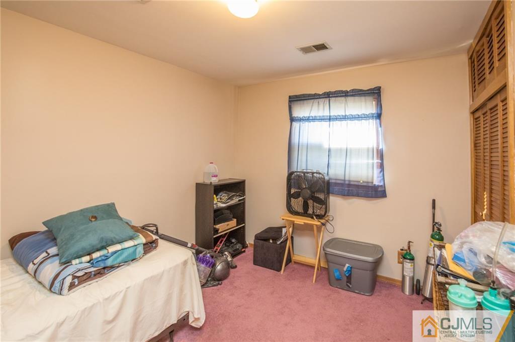 48 Caldwell Road Edison, NJ 08817 - Photo 8 of 24 a bedroom with furniture and a window