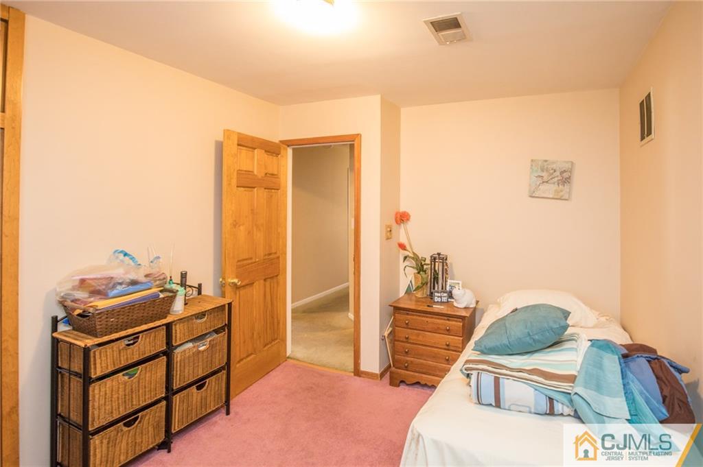 48 Caldwell Road Edison, NJ 08817 - Photo 9 of 24 a bedroom with furniture and a window