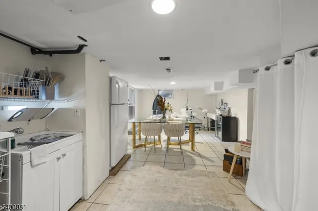 a view of a kitchen with fridge and workspace
