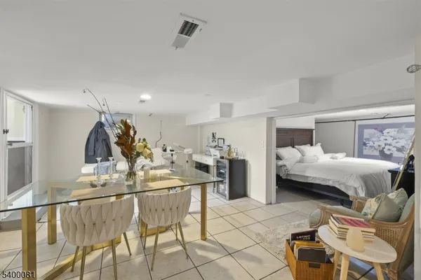 a living room with furniture and kitchen view