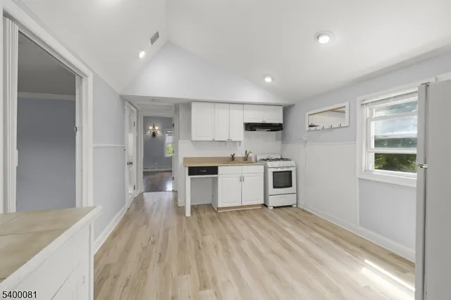a kitchen with stainless steel appliances a refrigerator and a stove top oven