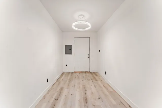 a view of a room with wooden floor and sink