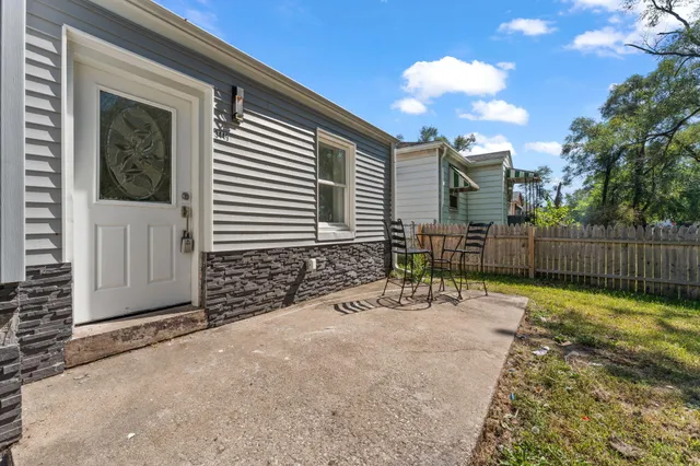 a view of backyard with wooden fence