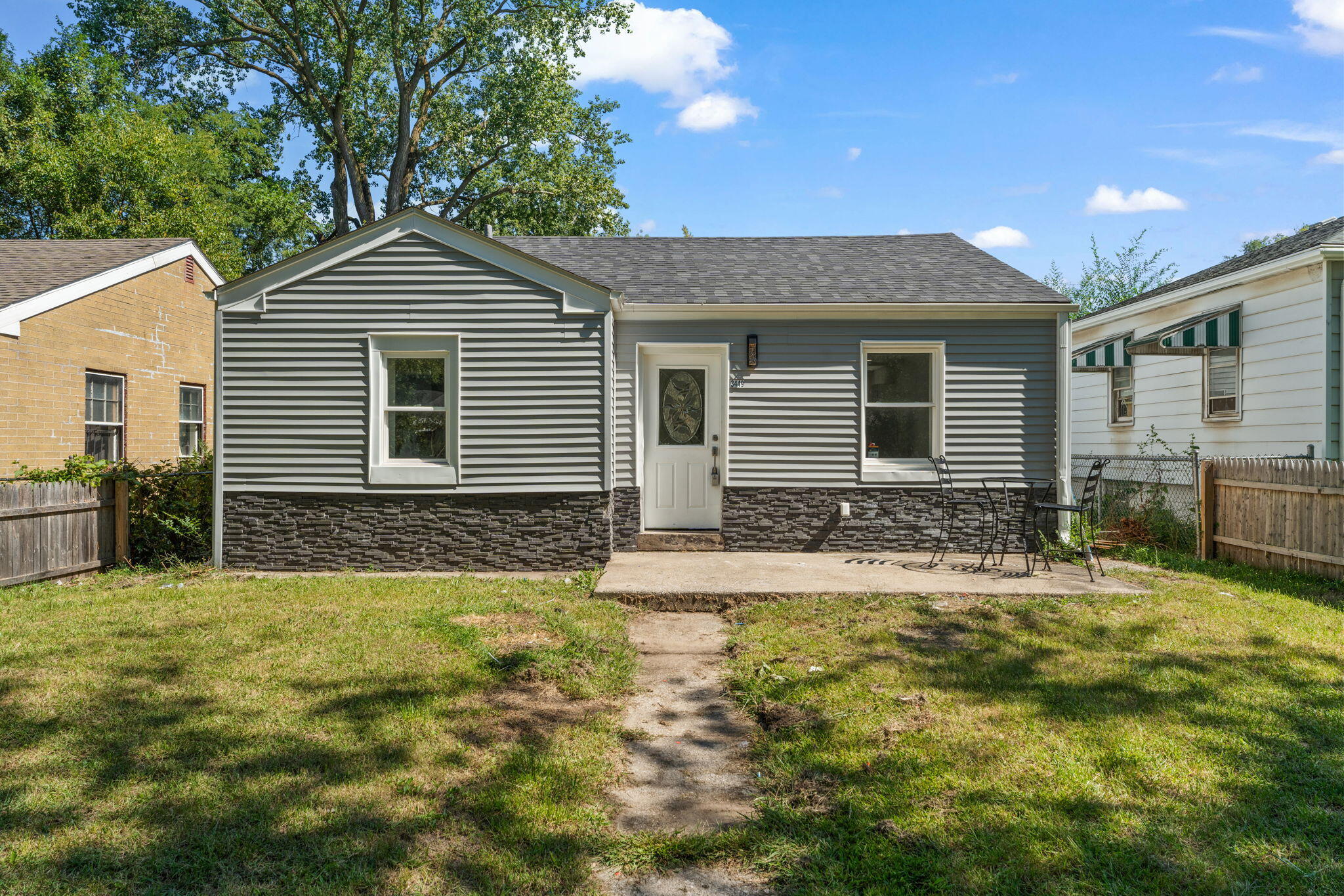 3449 Buchanan Street Gary, IN 46408 - Photo 2 of 15 a front view of a house with a yard