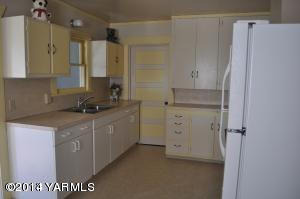 802 Estes Road Yakima, WA 98908 - Photo 5 of 26 a kitchen with a refrigerator sink and cabinets