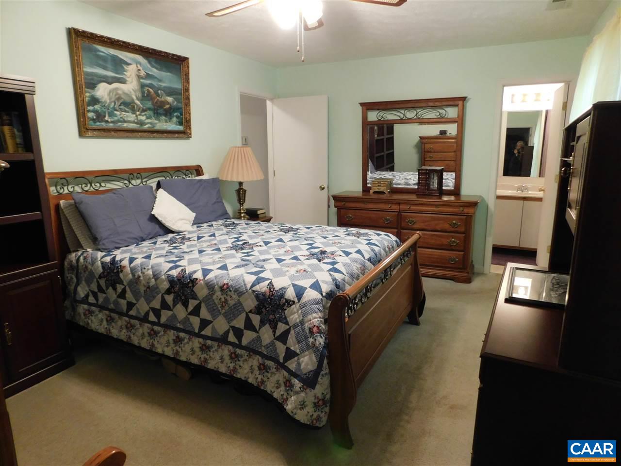 788 Carnation Road Ruckersville, VA 22968 - Photo 6 of 9 a bedroom with a bed and a flat screen tv