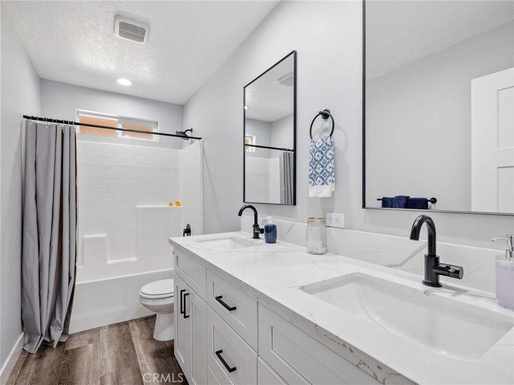 24162 Shoshone Road Apple Valley, CA 92307 - Photo 23 of 40 a bathroom with a double vanity sink mirror double and shower