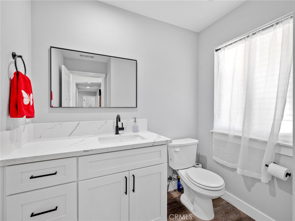 24162 Shoshone Road Apple Valley, CA 92307 - Photo 24 of 40 a bathroom with a toilet sink and mirror