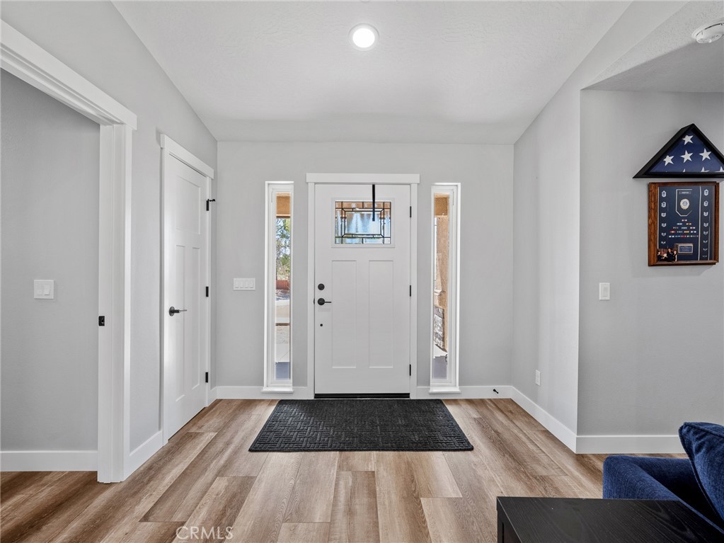 24162 Shoshone Road Apple Valley, CA 92307 - Photo 3 of 40 a view of a bedroom with wooden floor and bed