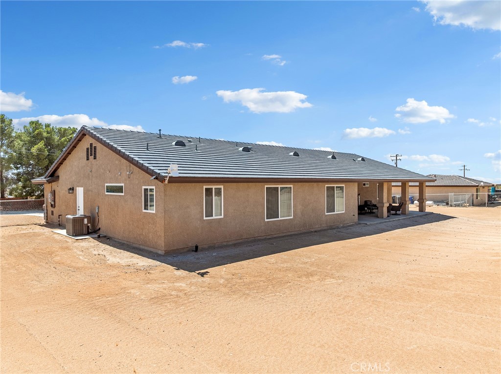 24162 Shoshone Road Apple Valley, CA 92307 - Photo 29 of 40 a front view of a house with a yard