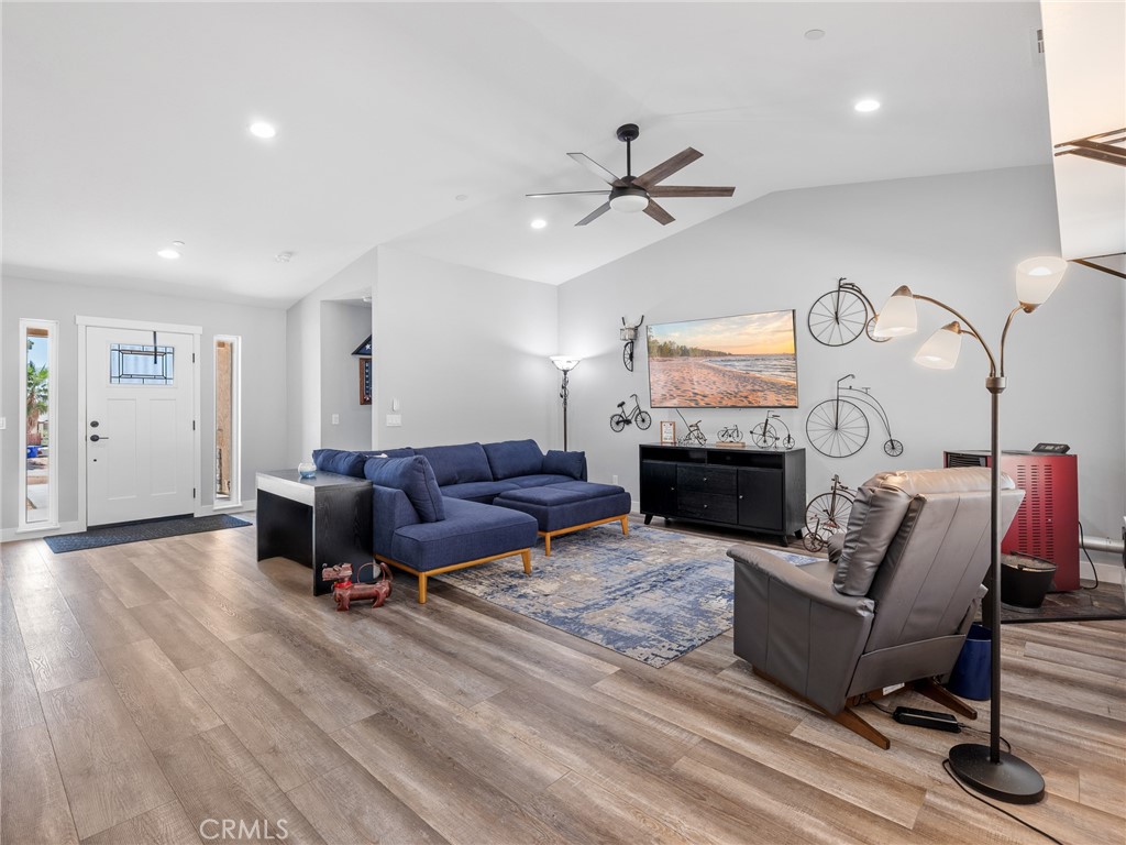 24162 Shoshone Road Apple Valley, CA 92307 - Photo 39 of 40 a living room with furniture a fireplace and a ceiling fan