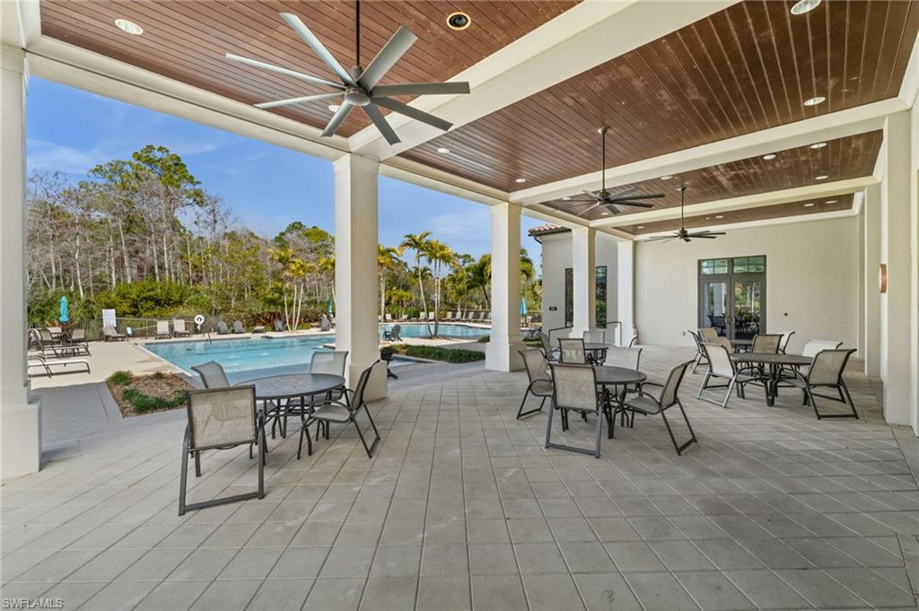 4754 Abaca Circle Naples, FL 34119 - Photo 42 of 46 a view of a patio with table and chairs and potted plants