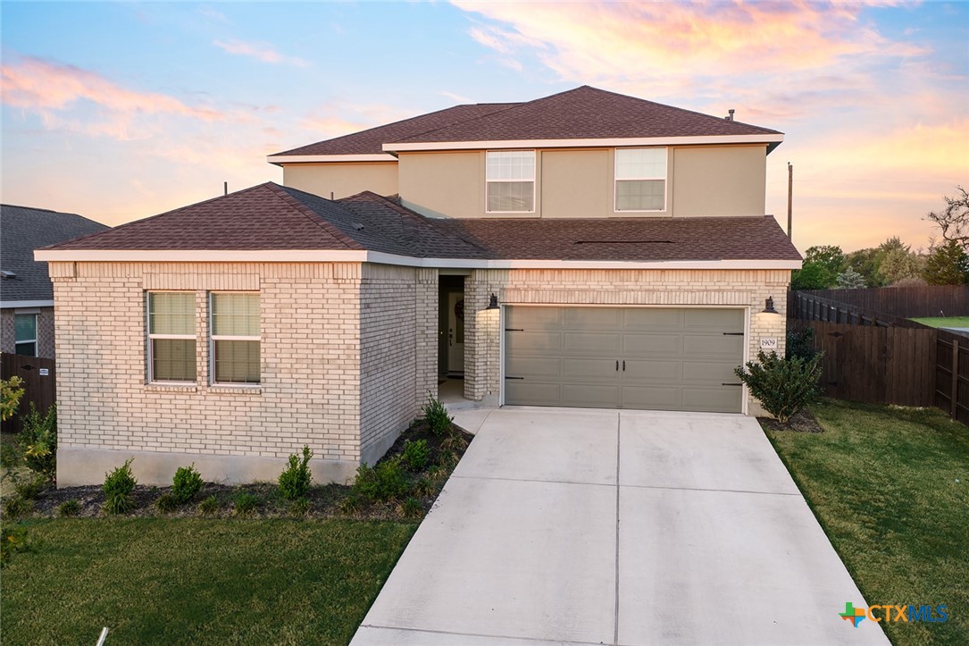 1909 Four Waters Loop Georgetown, TX 78628 - Photo 1 of 35 a front view of a house with a yard