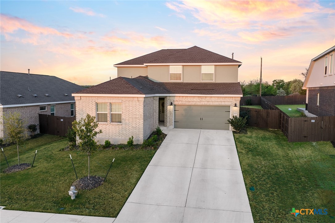 1909 Four Waters Loop Georgetown, TX 78628 - Photo 2 of 35 a front view of a house with a yard