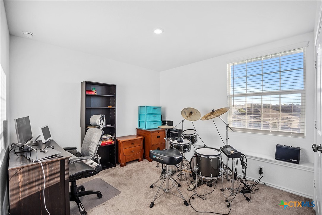 1909 Four Waters Loop Georgetown, TX 78628 - Photo 23 of 35 a view of a workspace with furniture and a window