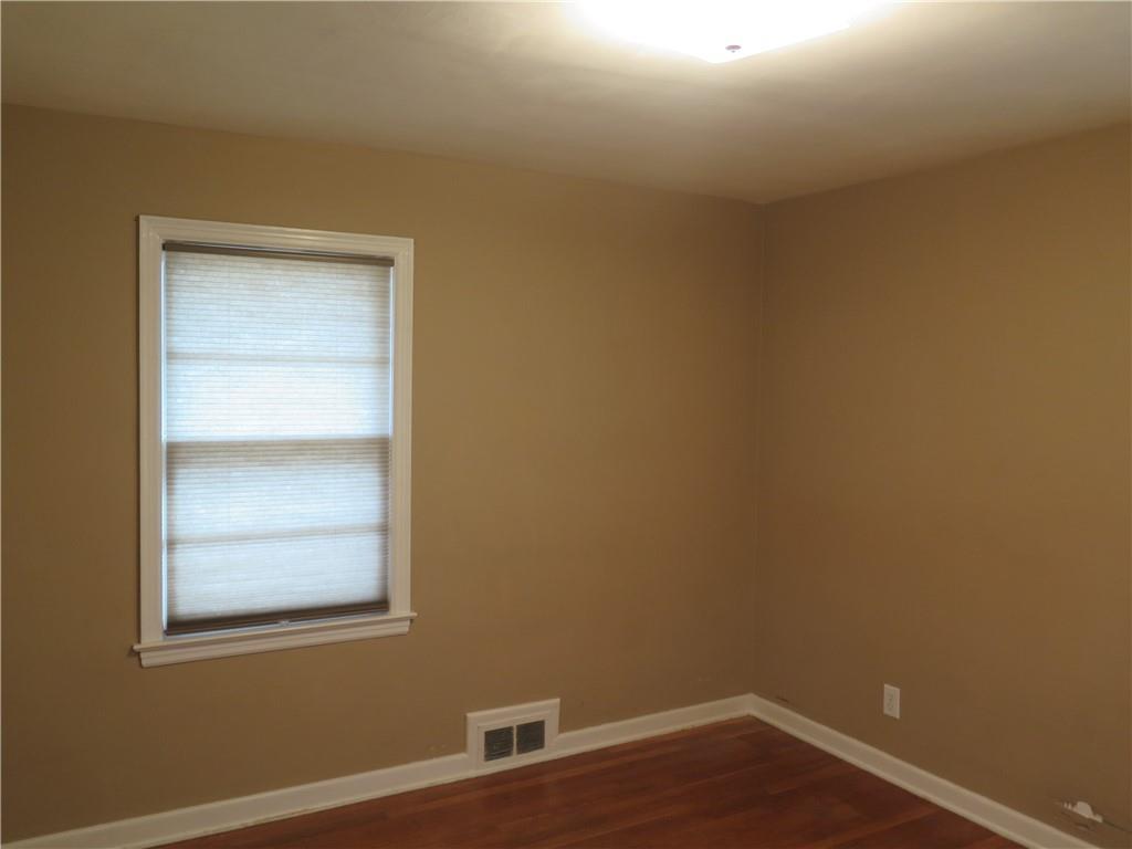 353 Mountain View Drive Northwest Gainesville, GA 30501 - Photo 5 of 8 a view of an empty room with wooden floor and a window