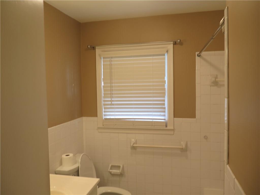 353 Mountain View Drive Northwest Gainesville, GA 30501 - Photo 8 of 8 a bathroom with a toilet a sink and a window