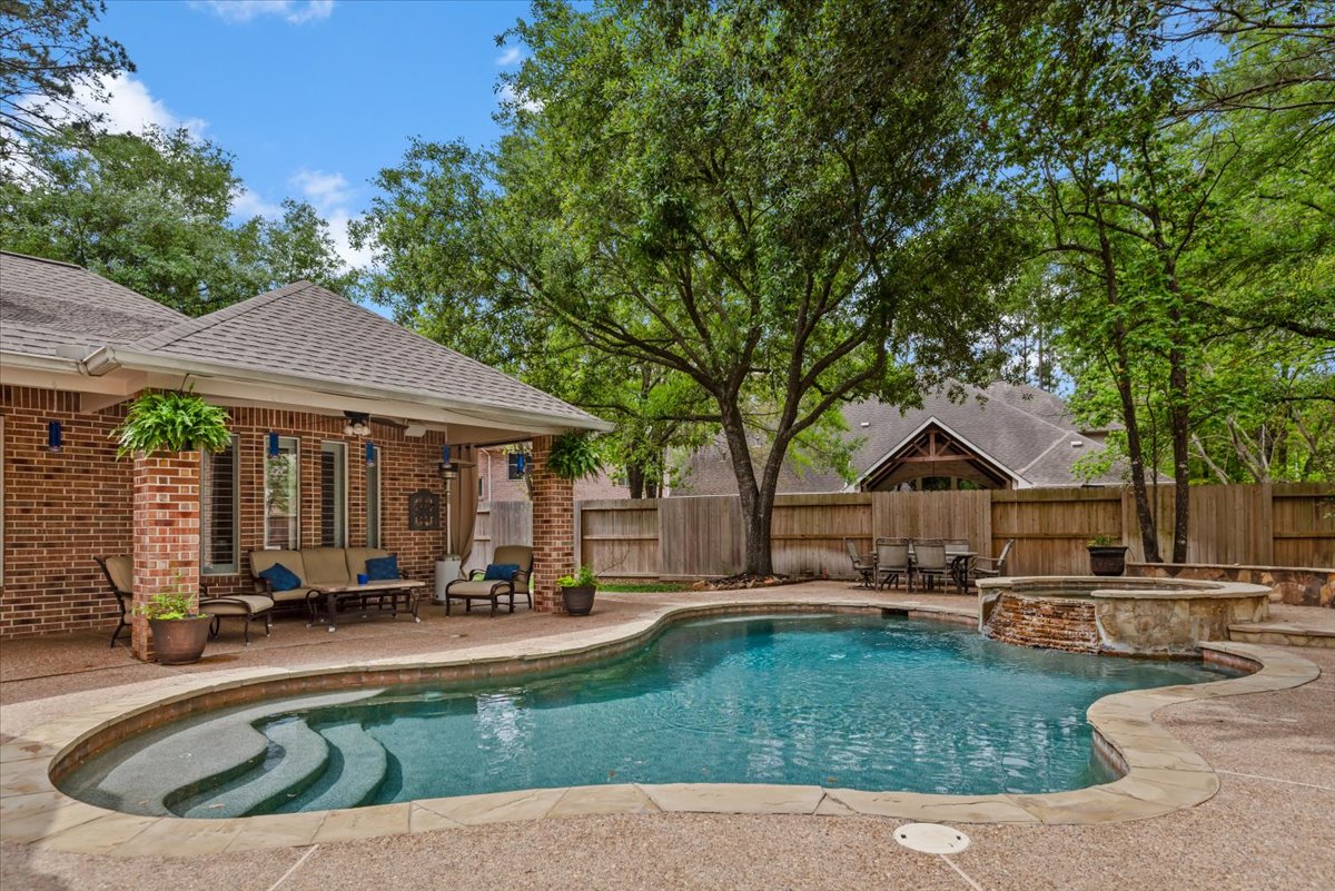 15519 Stallion Point Circle Cypress, TX 77429 - Photo 35 of 37 The property features a brick exterior with a covered patio area and a swimming pool