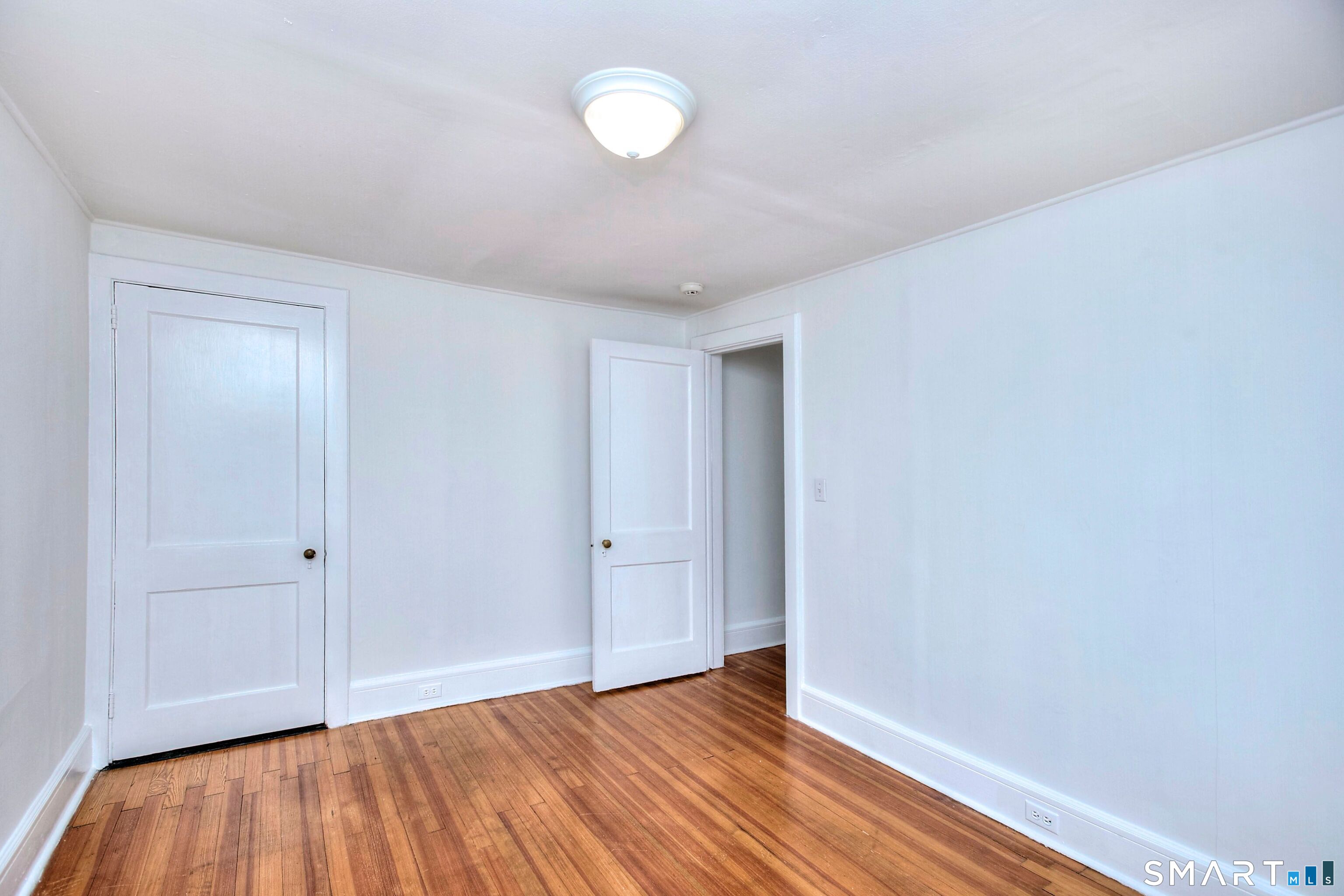 94 Honey Hill Road Wilton, CT 06897 - Photo 15 of 18 a view of an empty room and wooden floor