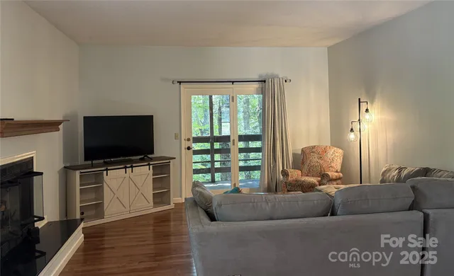 a living room with furniture and a flat screen tv