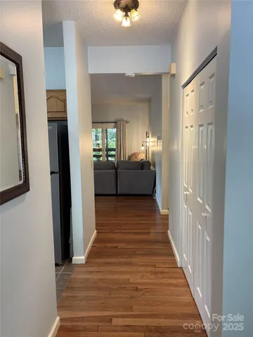 a view of a hallway view with wooden floor and staircase