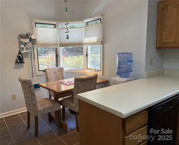 a view of a dining room with furniture window and outside view