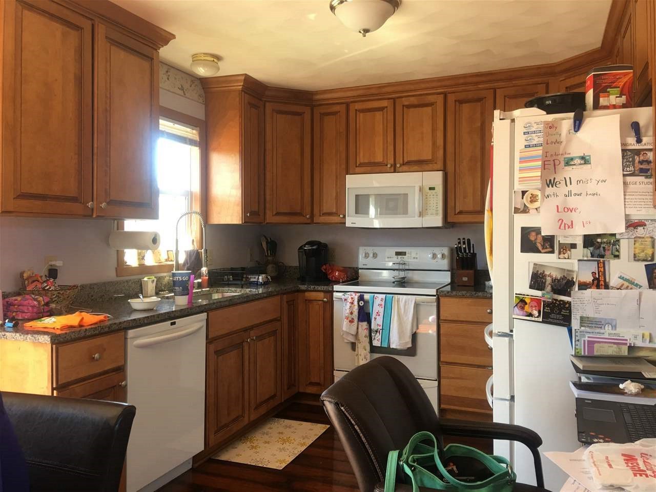 3975 Linden Road Rockford, IL 61109 - Photo 7 of 8 a kitchen with stainless steel appliances granite countertop a stove top oven a sink dishwasher and cabinets with wooden floor