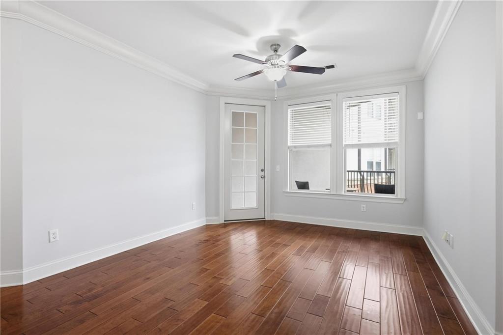 901 Abernathy Road Northeast, Unit 3080 Atlanta, GA 30328 - Photo 5 of 21 a view of an empty room with wooden floor and a window
