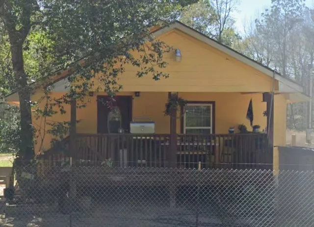 a view of a house with wooden fence