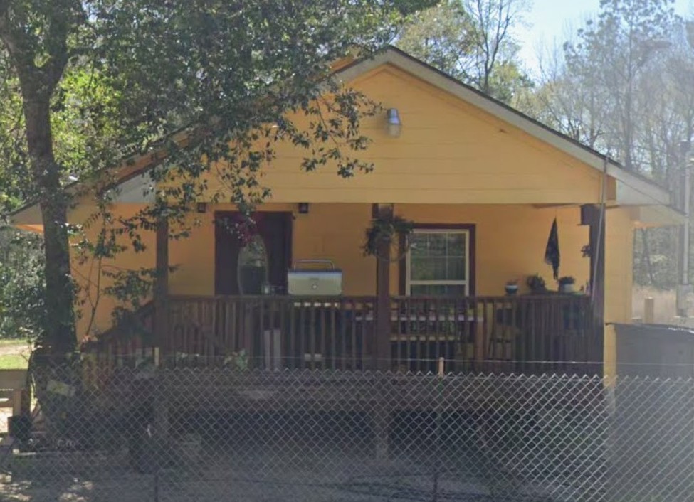 a view of a house with wooden fence