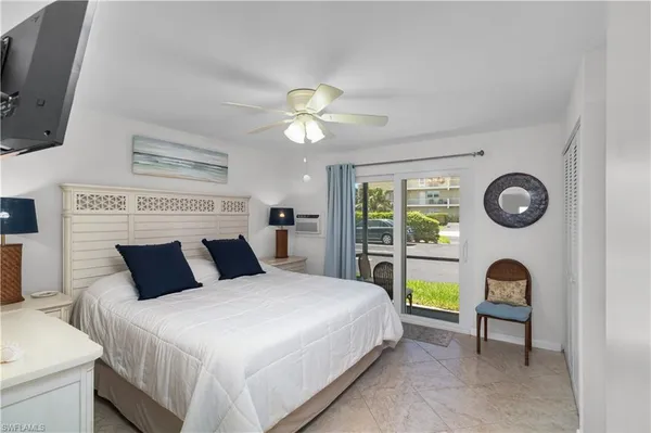 a bedroom with a large bed and a fireplace