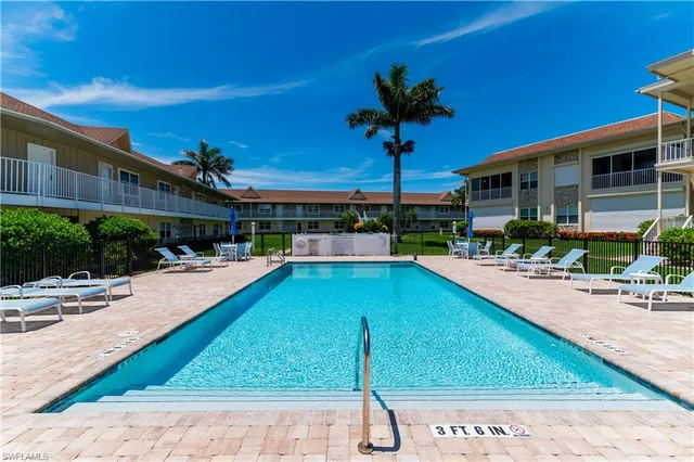a swimming pool with outdoor seating and yard