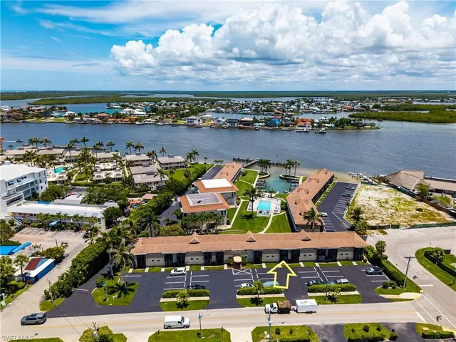 a living room with furniture a chandelier and a flat screen tv