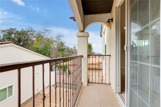 a view of a white house with a yard and plants