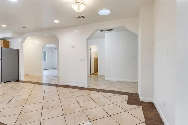 an empty room with wooden floor and mirror