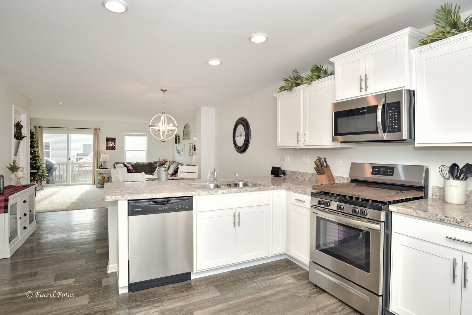 2371 Upland Road Pingree Grove, IL 60140 - Photo 6 of 15 a kitchen with stainless steel appliances granite countertop a stove top oven a sink dishwasher and white cabinets with wooden floor