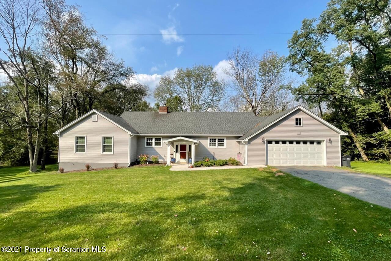 129 State Rte 2023 Forest City, PA 18421 - Photo 1 of 17 a house that is sitting in the grass with tress in the background