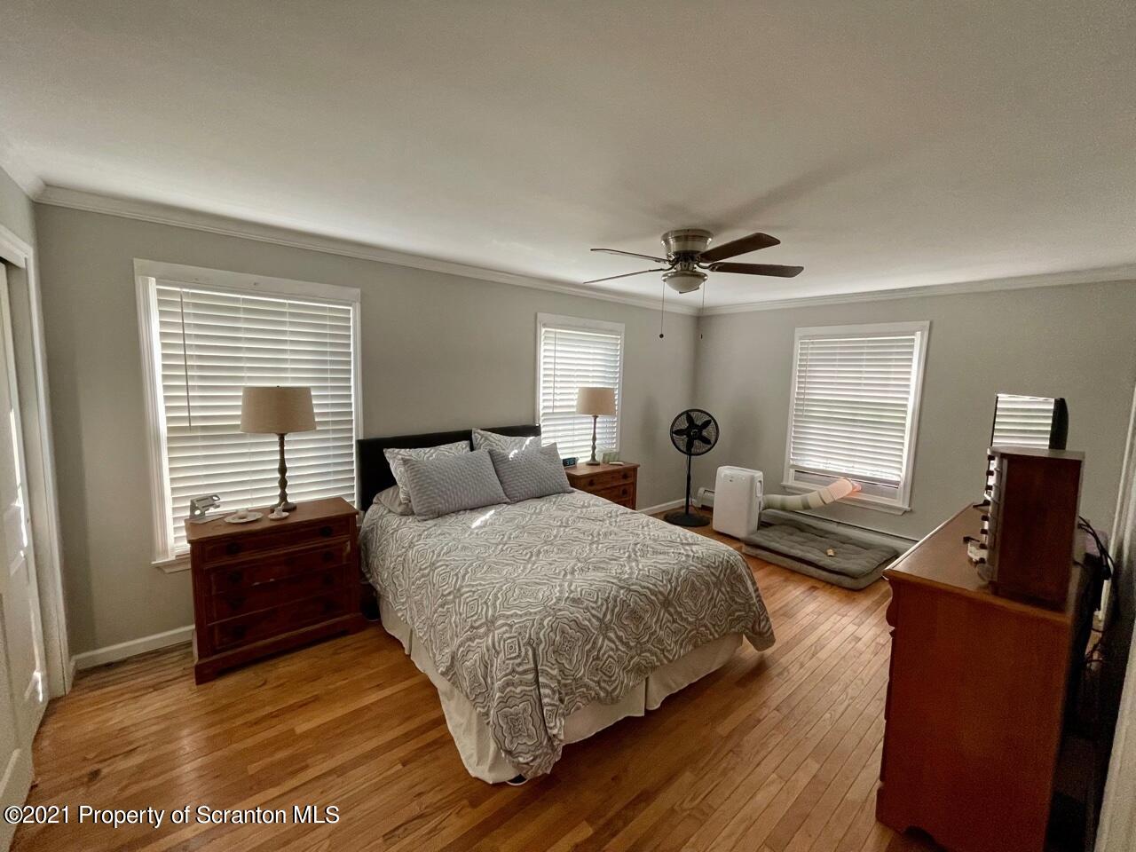 129 State Rte 2023 Forest City, PA 18421 - Photo 13 of 17 a bedroom with a bed and wooden floor