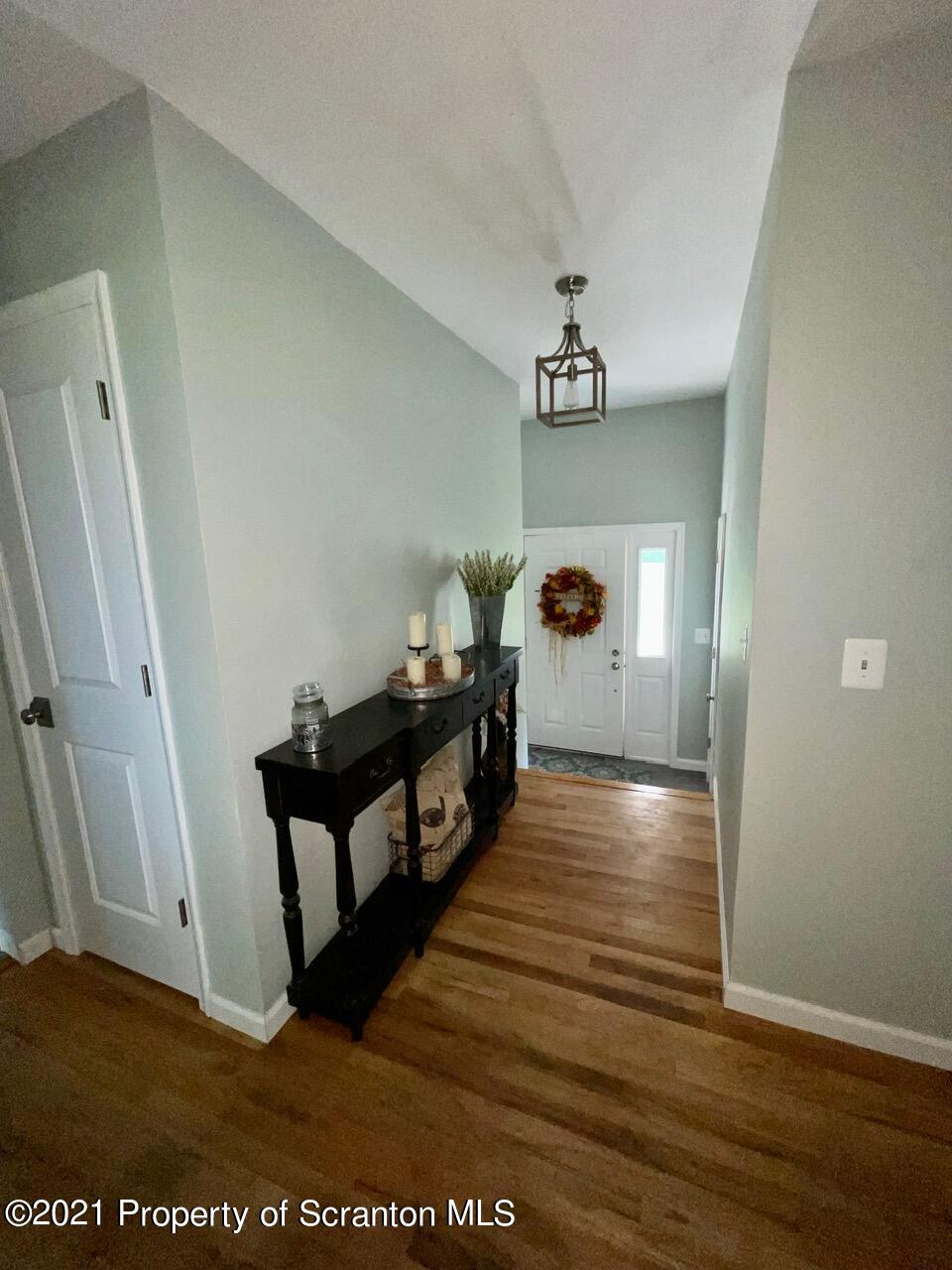 129 State Rte 2023 Forest City, PA 18421 - Photo 10 of 17 a view of a hallway with wooden floor and staircase