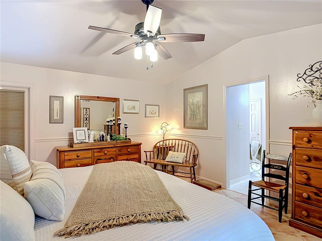 1395 Maytown Road Osteen, FL 32764 - Photo 29 of 65 a bedroom with furniture and wooden floor