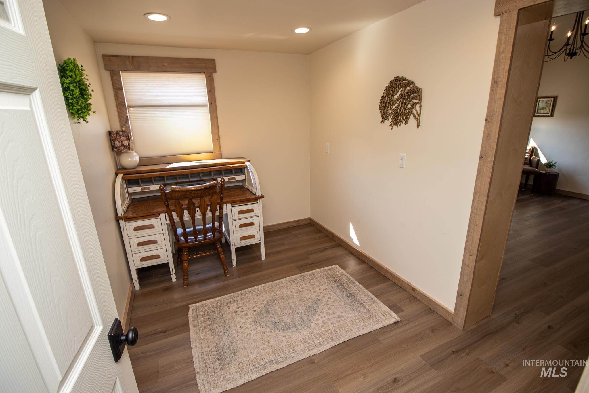 263 Glory Lane Orofino, ID 83544 - Photo 30 of 48 Office area with dark wood finished floors and a chandelier