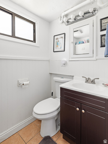 372 800 East Provo, UT 84606 - Photo 22 of 29 Bathroom featuring a vanity with a white countertop and dark wood-finish cabinetry, a white toilet, and light brown floor tiling
