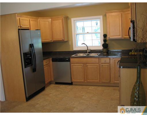 5 Chandler Road Somerset, NJ 08873 - Photo 5 of 10 a kitchen with stainless steel appliances granite countertop a refrigerator a sink a stove and white cabinets