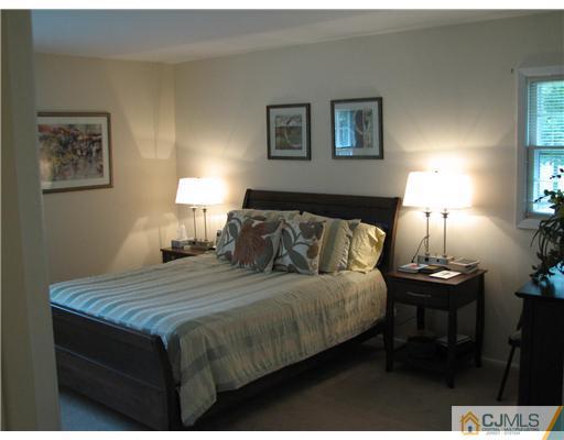 5 Chandler Road Somerset, NJ 08873 - Photo 7 of 10 a bedroom with a bed and a lamp on table