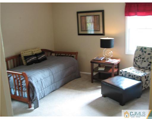 5 Chandler Road Somerset, NJ 08873 - Photo 8 of 10 a bedroom with a bed and a couch