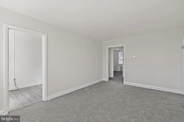 a view of an empty room and closet area