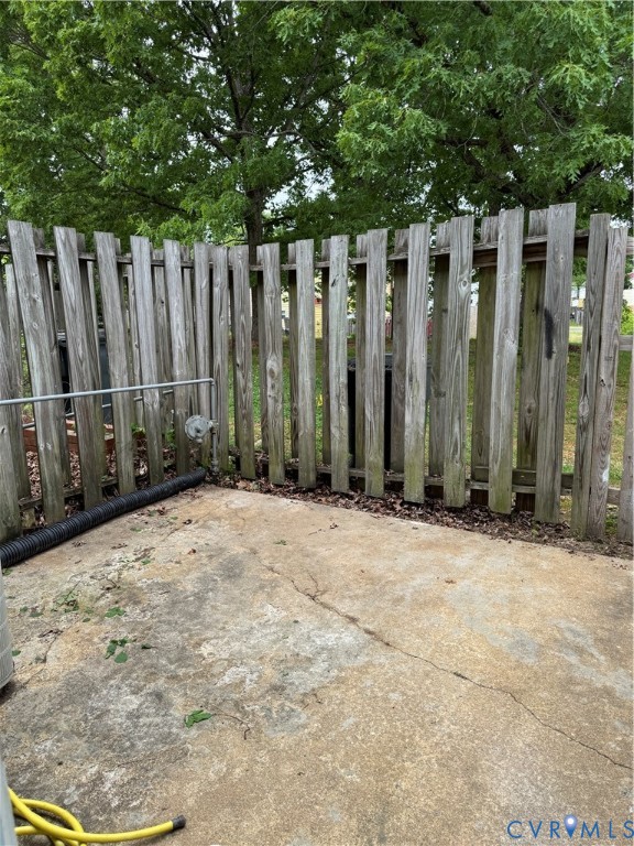 419 Roxana Road Henrico, VA 23075 - Photo 15 of 17 Private outdoor patio area with a wooden privacy f